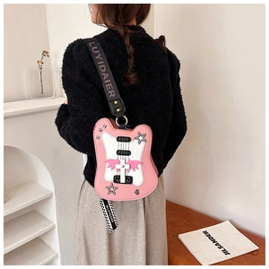 Pink and white guitar shaped crossbody bag with star and wing details on a model