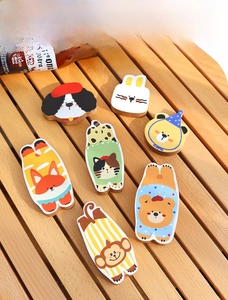 Close-up of beech wood animal bottle openers featuring cartoon prints on a wooden table