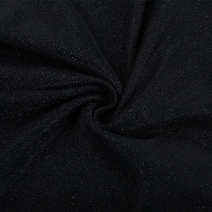 Macro shot of shimmering black glitter fabric with elegant spiral draping and texture