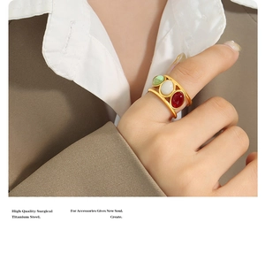 Detail of vintage surgical titanium steel wide ring with three-color gemstone inlay