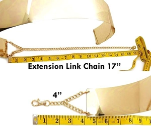 Detail view of golden wide metal belt with a 17 inch adjustable extension chain link
