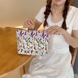 Close-up of tulip print canvas makeup bag showing the smooth metal zipper closure