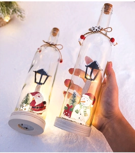 Close-up of LED glowing Christmas glass jars with Santa and Snowman miniatures