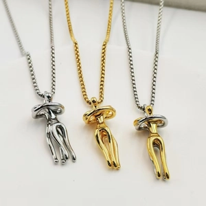 Polished hugging couple pendant necklaces in silver, gold, and bicolor finishes