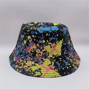 Close-up of bucket hat showing artistic colorful ink splash graffiti and textured fabric