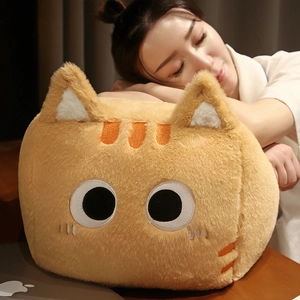Close-up of a cozy orange cat plush pillow held by a woman in a comfortable home setting