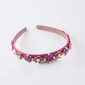 Detail of rose pink satin headband featuring rhinestones, pearls and gemstone accents