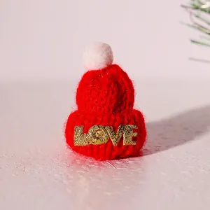 Mini red knit Christmas hat with LOVE glitter text and white pompom 3.5x5.5cm detail