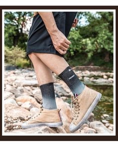 Detail of gradient athletic socks with Aurora embroidery paired with high-top canvas shoes