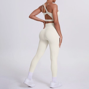 Detail of one-shoulder sports bra back and high-waist yoga leggings in cream white