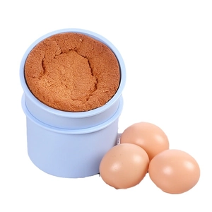 Round silicone baking mold with a freshly baked golden sponge cake and brown eggs