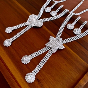 Macro view of crystal heart and star jewelry sets with sparkling necklaces and earrings