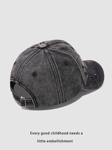 Detail of adjustable metal buckle on washed black denim baseball cap with distressed finish
