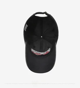 Detailed interior of black cotton baseball cap showing stitching, sweatband and embroidery
