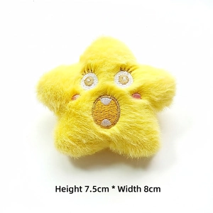 Detail of yellow star plush brooch with embroidery, dimensions H 7.5cm by W 8cm