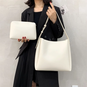 Minimalist cream tote bag and pouch set on a fashion model for casual everyday style