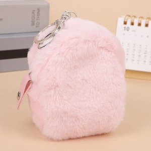 Pink plush mini backpack keychain wallet with silver clasp on a light surface