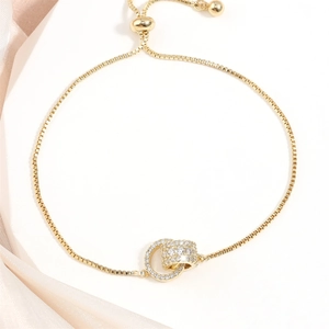Bracciale dorato regolabile con due cerchi intrecciati e micro-pavé di zirconi lucidi