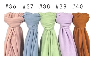 Detail view of multicolored pearl chiffon shawls in rolled display numbered #36 to #40