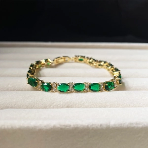 Elegant gold bracelet with oval emerald green zircon and pavé crystal accents