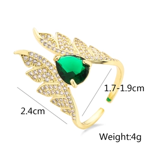Detailed view of adjustable gold wing ring with green zircon and size dimensions
