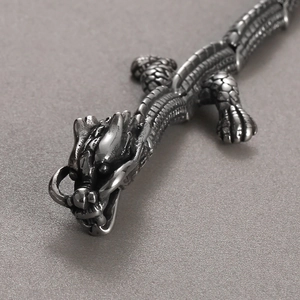 Detailed close-up of intricate dragon head textures on a gold-plated stainless steel bracelet