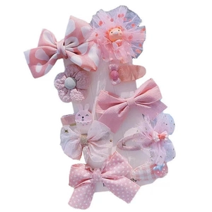 Pink girls hair clip set featuring fabric bows, tulle flowers, and cute resin animals