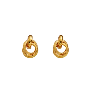 Detail of gold geometric earrings with a mix of polished and matte triple ring design
