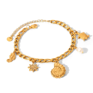 Detail of 18k gold plated ocean bracelet with starfish, seashell, and pearl charms