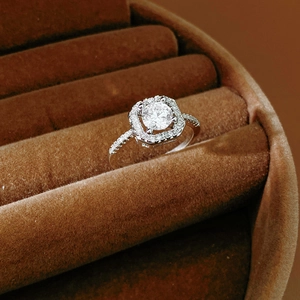 Macro shot of a sparkling flower zircon halo ring displayed in a luxury brown velvet box