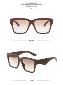 Detail view of square brown gradient sunglasses with golden metal hinge accents