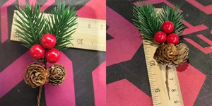 Detailed view of artificial Christmas pine needles with red berries and pine cones