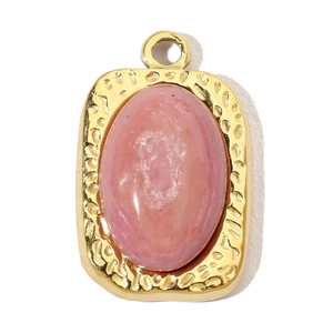 Macro shot of oval pink gemstone pendant with gold hammered texture stainless steel frame