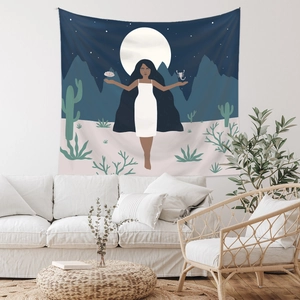 Detail of bohemian wall tapestry showing an artistic illustration over a white sofa