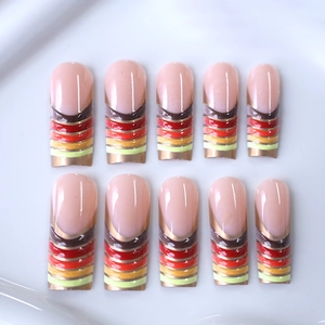 Long trapezoid nude nails with colorful gradient stripes and gold metallic tips