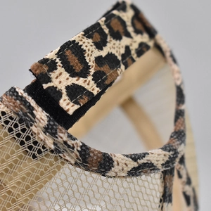 Detail of leopard print ponytail cap with breathable mesh and adjustable velcro strap