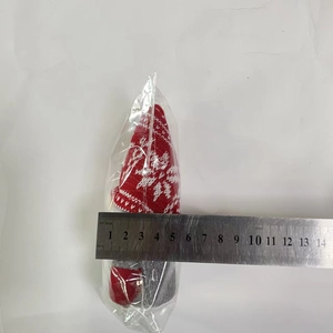 Detailed view of knitted Christmas gnome showing 5.5cm width measurement with a ruler