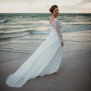 Elegant white lace long sleeve beach bridal gown with V-neck, open back and long train