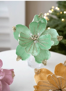 Macro detail of mint green velvet artificial Christmas flower with gold glitter and beads