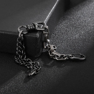 Detailed view of a black metal Cuban link chain bracelet with a sturdy lobster clasp