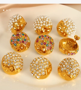 Close-up of luxury heart dome earrings with white pearls and sparkling crystal studs
