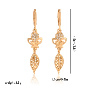 Detail view of long champagne gold flower earrings with zircon and size dimensions