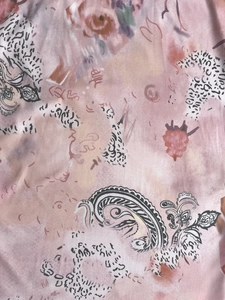 Close-up of double-layer mesh fabric with pink paisley and butterfly print details