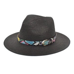 Detail of black straw fedora hat featuring a vibrant colorful snakeskin pattern ribbon