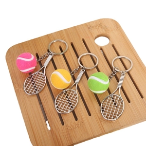 Three-piece tennis racket and ball keychain set in pink, yellow, and green colors