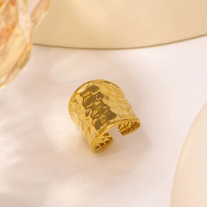 Golden wide open ring with hammered water ripple texture in a minimalist luxury style