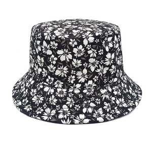 Close-up of floral bucket hat with high-density white flower print on black cotton fabric