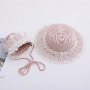 Detailed view of pink straw hat and matching crossbody bag with lace and sequins