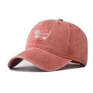 Close-up of a vintage washed cotton baseball cap featuring detailed dog embroidery