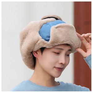 Detail of warm winter trapper hat with thick faux fur lining and ear flaps for cold weather